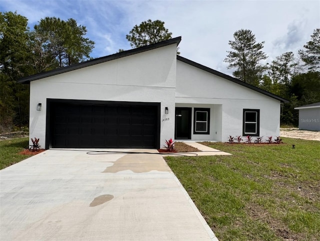 view of front of house with stucco siding, driveway, an attached garage, and a front yard