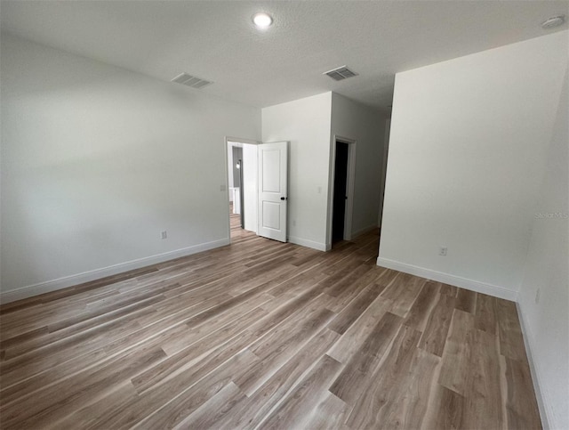 spare room featuring hardwood / wood-style flooring