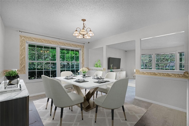 carpeted dining room with a textured ceiling, a wealth of natural light, and an inviting chandelier