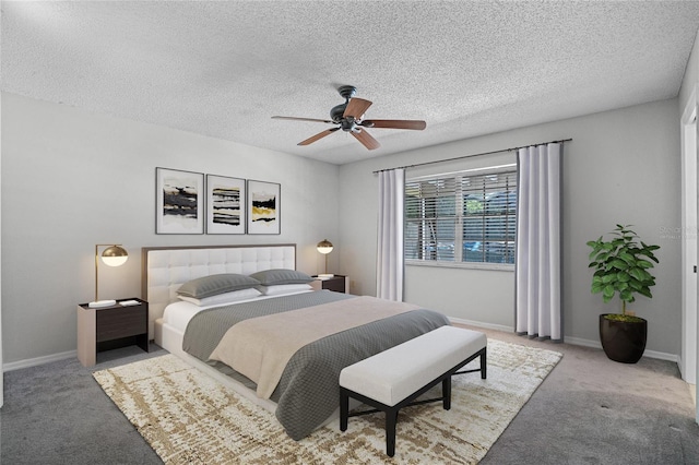 bedroom featuring light carpet, ceiling fan, and a textured ceiling