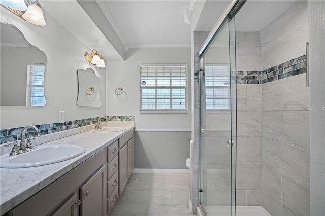 bathroom featuring ornamental molding, double sink, toilet, and oversized vanity