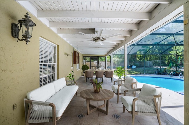 exterior space featuring glass enclosure, ceiling fan, and outdoor lounge area