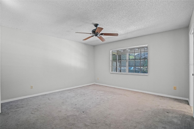 carpeted spare room featuring a textured ceiling and ceiling fan