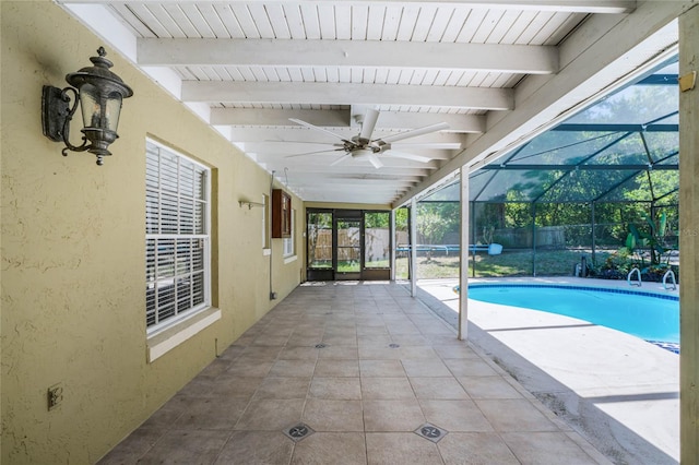 view of swimming pool featuring ceiling fan, a lanai, and a patio