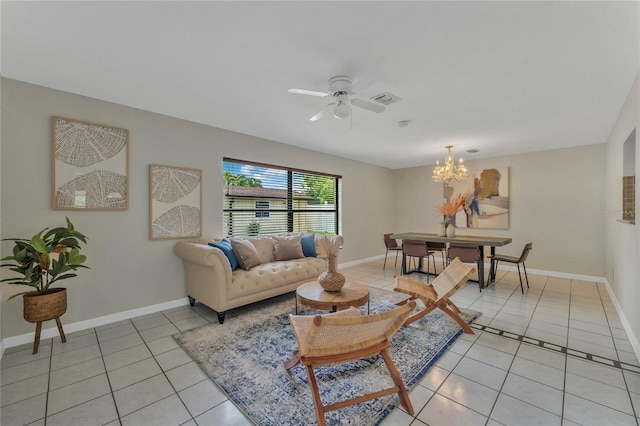 tiled living room featuring ceiling fan with notable chandelier