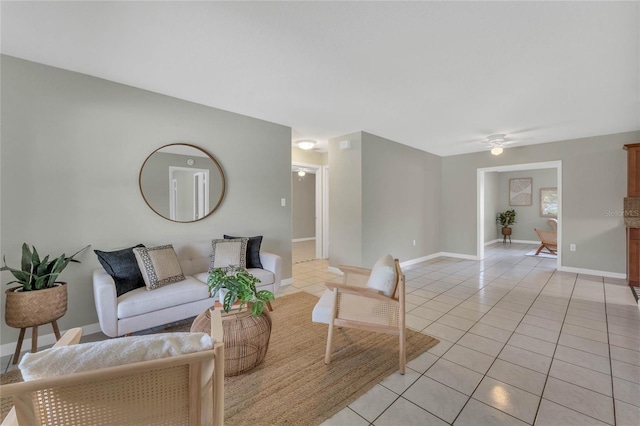 living room featuring light tile patterned floors and ceiling fan