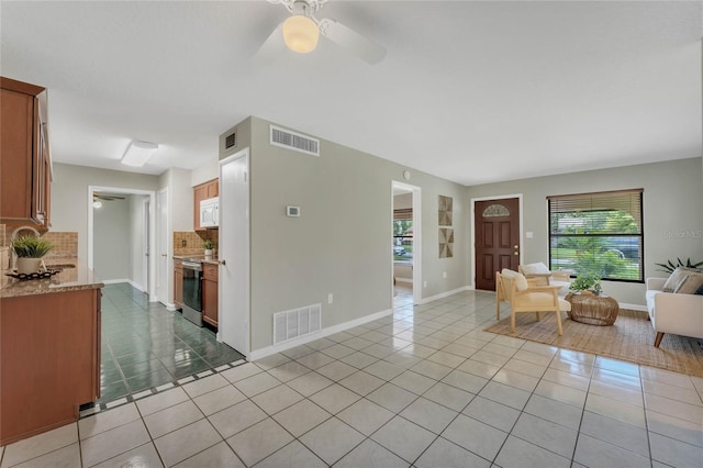 living room with ceiling fan and light tile patterned floors