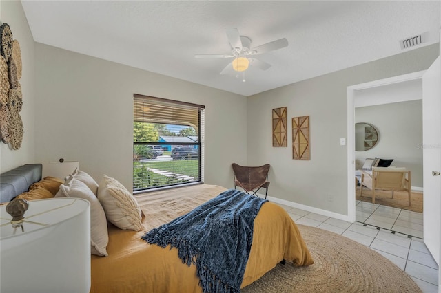 tiled bedroom featuring ceiling fan