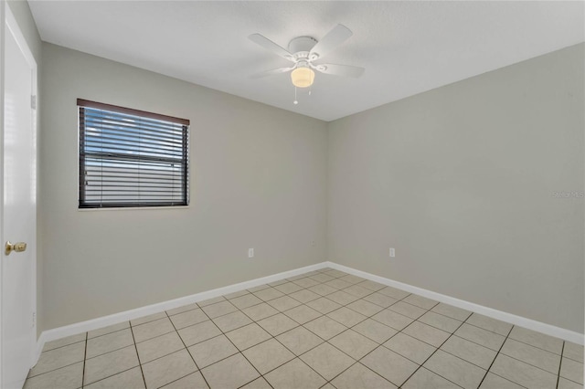 spare room with light tile patterned floors and ceiling fan