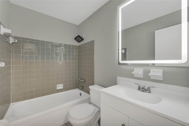 full bathroom featuring vanity, tiled shower / bath combo, and toilet