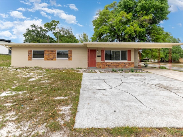 single story home with a front yard and a carport