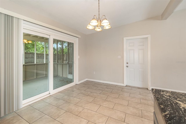 empty room featuring an inviting chandelier and light tile flooring