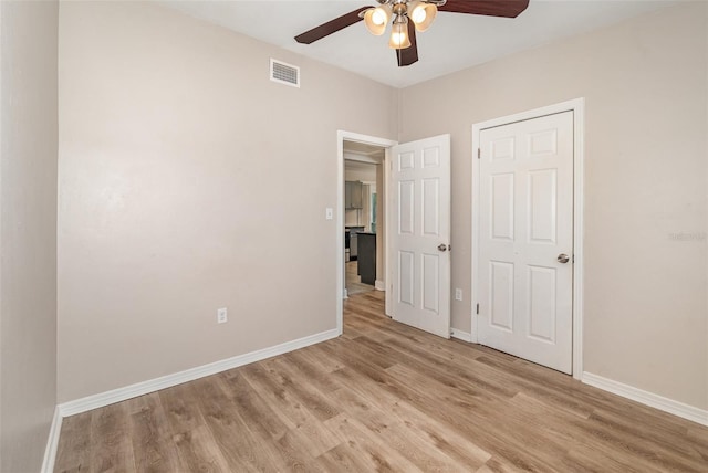 unfurnished bedroom with ceiling fan and light wood-type flooring