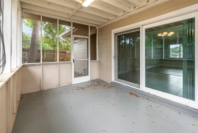 unfurnished sunroom with an inviting chandelier