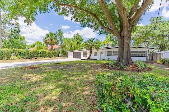 ranch-style home with a front lawn and a garage