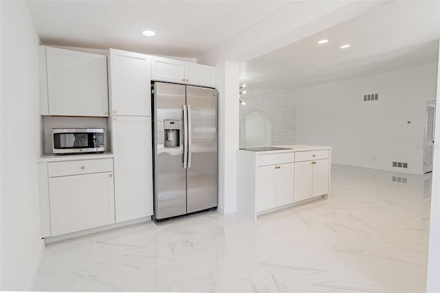 kitchen with white cabinets, light tile flooring, and stainless steel appliances