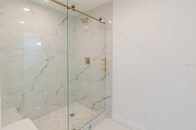 bathroom featuring a shower with shower door