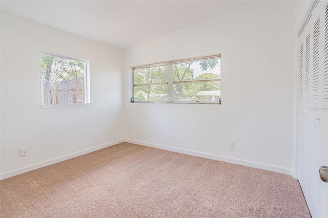 empty room featuring light carpet