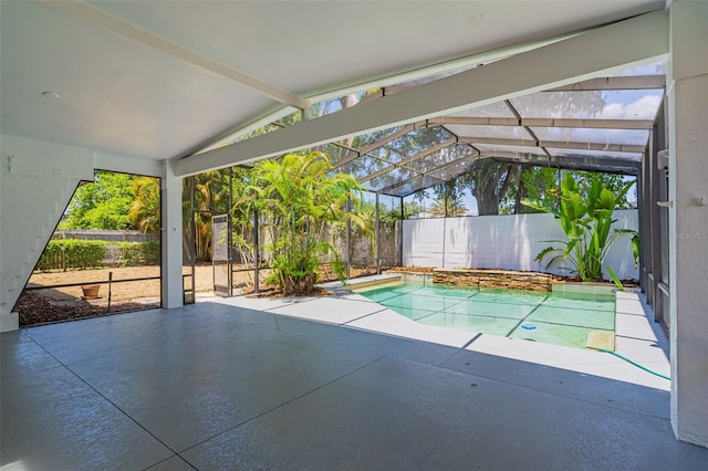 view of pool with a patio area and glass enclosure