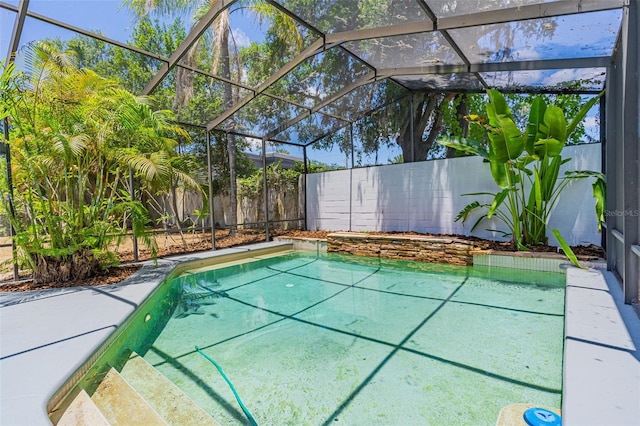 view of pool featuring glass enclosure