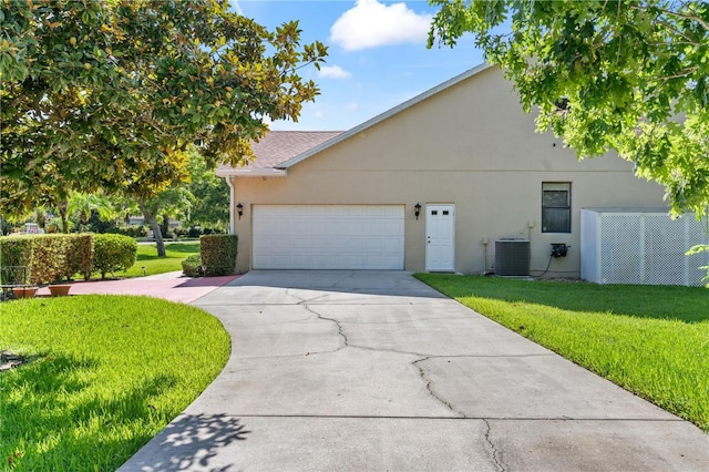 view of side of property featuring central AC, a garage, and a lawn