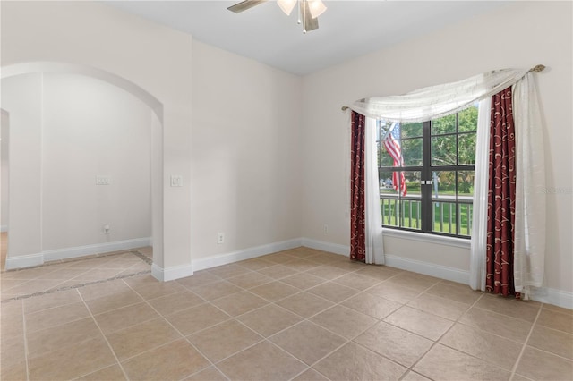 unfurnished room featuring light tile patterned floors and ceiling fan