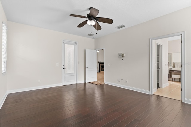 unfurnished bedroom with dark hardwood / wood-style flooring, ceiling fan, and ensuite bath