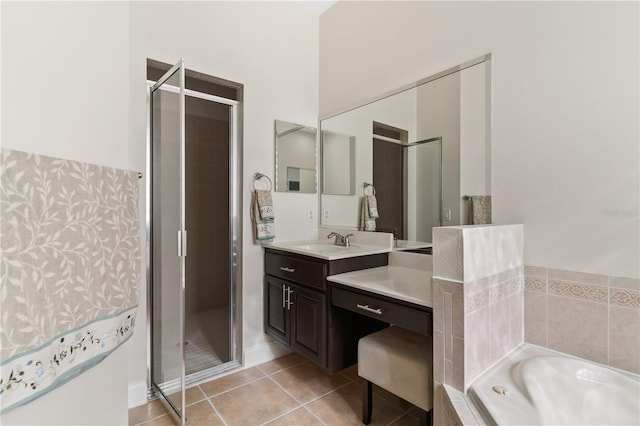 bathroom with vanity, independent shower and bath, and tile patterned flooring