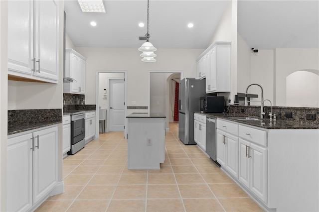 kitchen featuring light tile patterned flooring, sink, a kitchen island, stainless steel appliances, and white cabinets