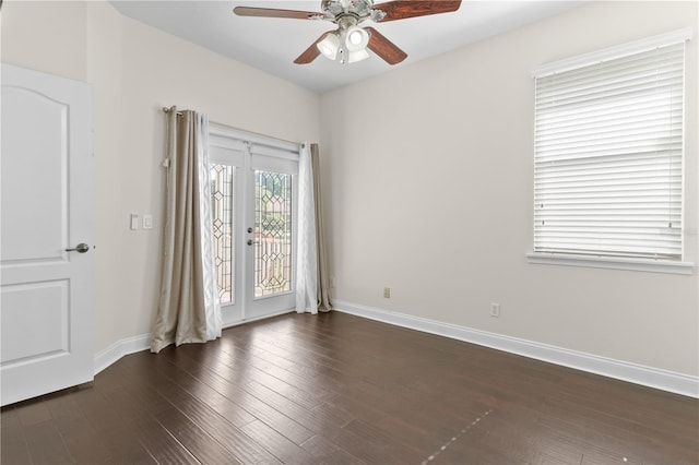 spare room with dark wood-type flooring, french doors, and ceiling fan