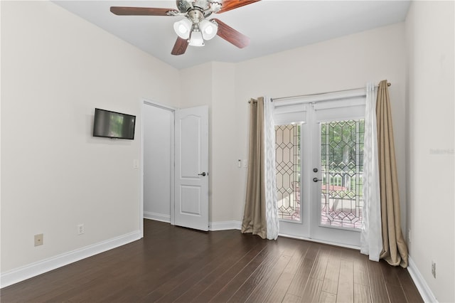 spare room with dark wood-type flooring, ceiling fan, and french doors