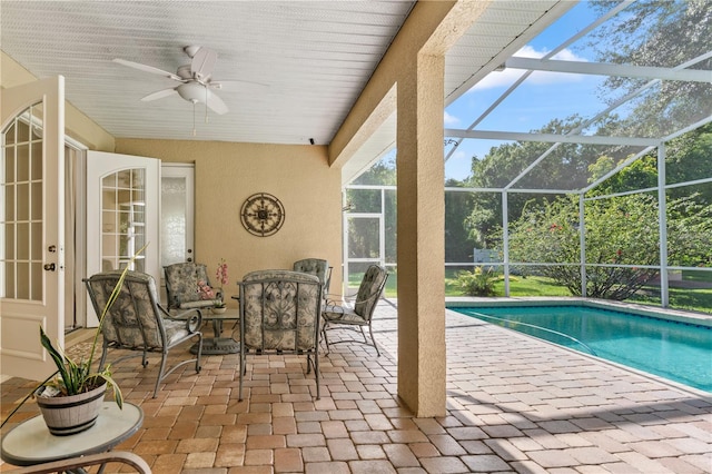 view of pool with a lanai, ceiling fan, and a patio area