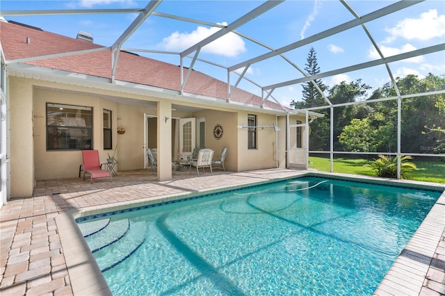 view of swimming pool with a patio and glass enclosure