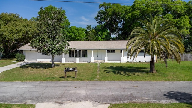 view of front of home with a front lawn and a garage