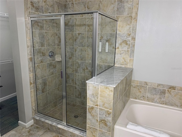 bathroom featuring tile patterned floors and shower with separate bathtub