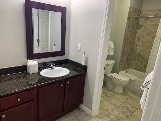 full bathroom with vanity, tiled shower / bath combo, and toilet