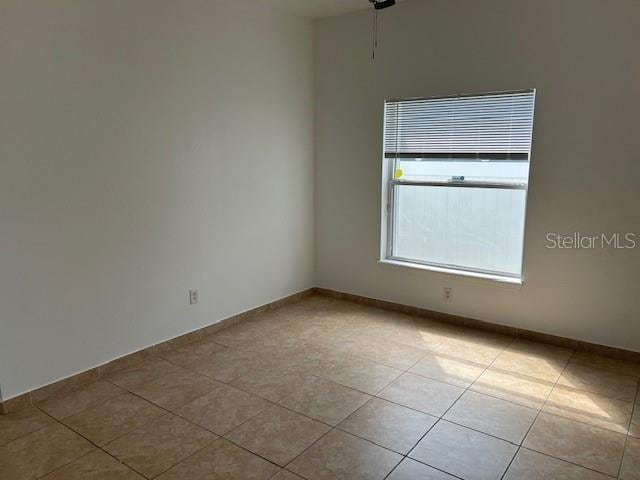 empty room with light tile patterned floors