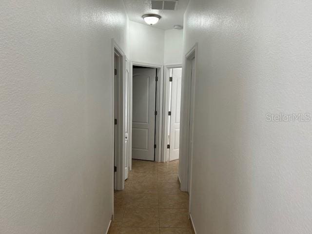 hallway featuring light tile patterned floors