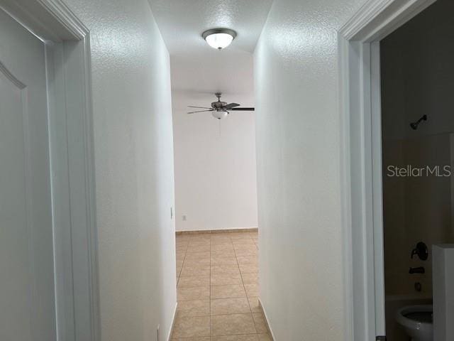 hallway featuring light tile patterned floors