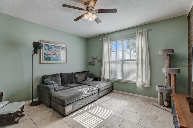 tiled living room with ceiling fan and a textured ceiling