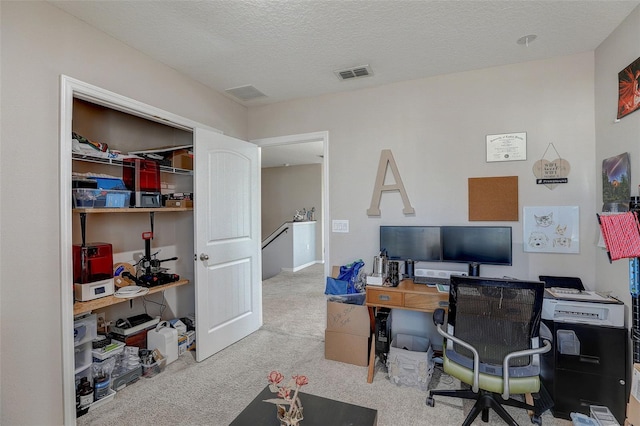 carpeted home office with a textured ceiling