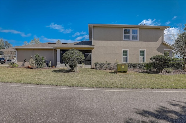 view of front of home with a front yard and central AC