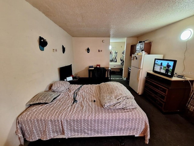 bedroom featuring white refrigerator, dark colored carpet, and a textured ceiling