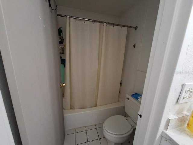 bathroom with toilet, tile floors, and shower / tub combo