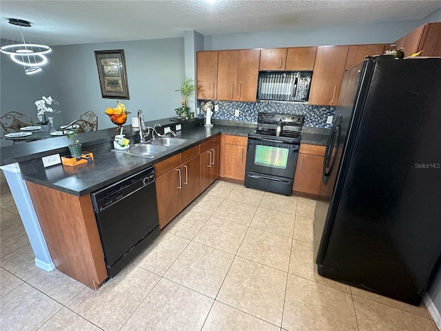 kitchen featuring kitchen peninsula, sink, backsplash, black appliances, and an inviting chandelier