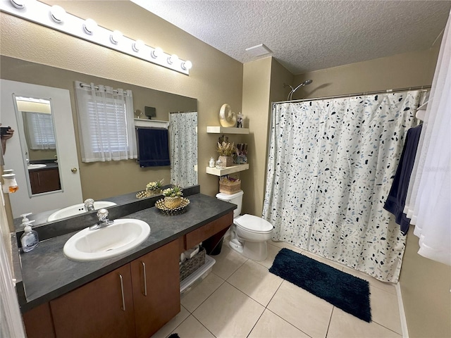 bathroom with toilet, tile flooring, a textured ceiling, and vanity