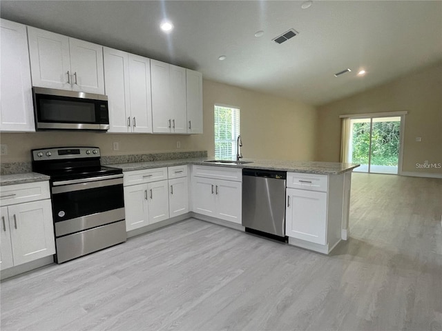 kitchen with stainless steel appliances, sink, and light wood-type flooring