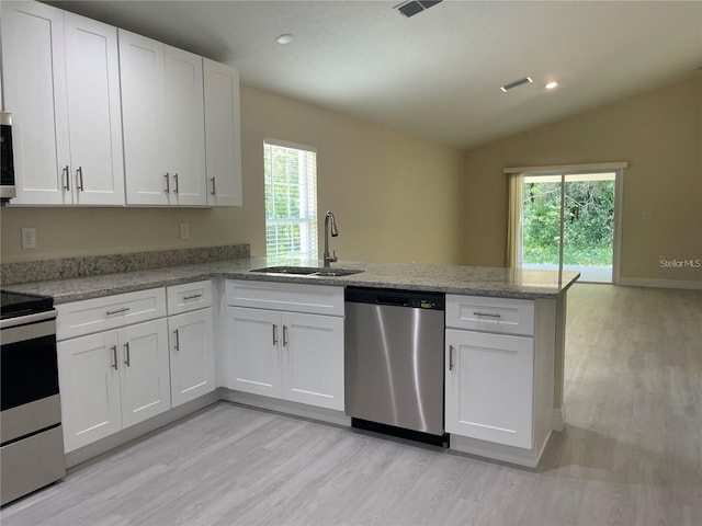 kitchen with white cabinets, appliances with stainless steel finishes, and sink