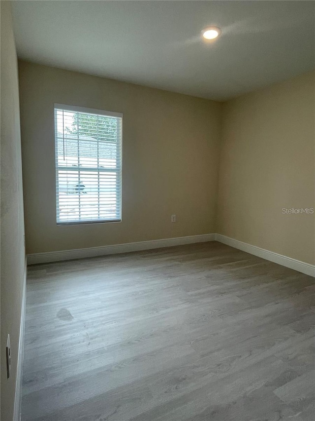 unfurnished room with light hardwood / wood-style flooring