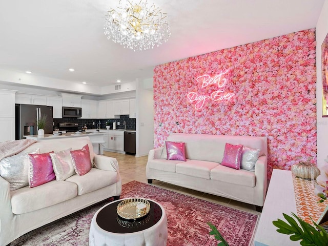 living room with an inviting chandelier, sink, and light tile floors